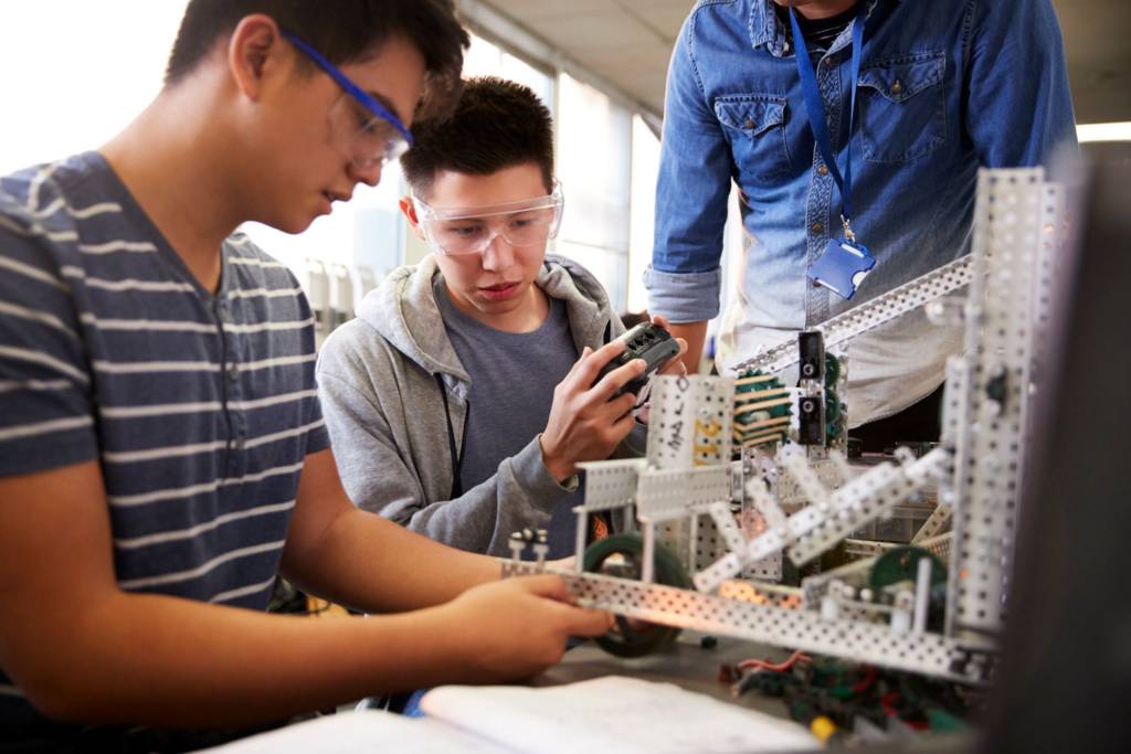 Two male students work on an engineering project