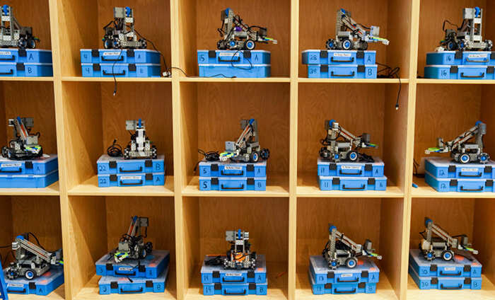 A cube shelf with small robots in every shelf