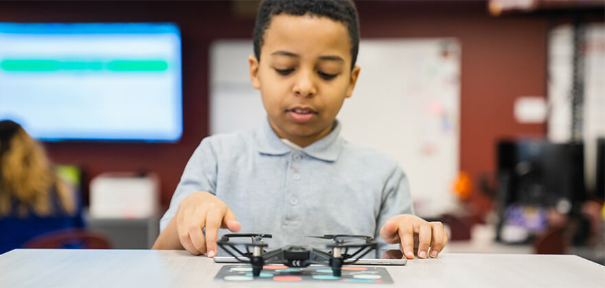 elementary-student-holding-a-drone.