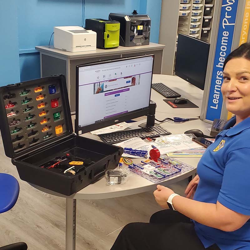 Educator learning to use SmartLab circuitry kit during facilitator training 
