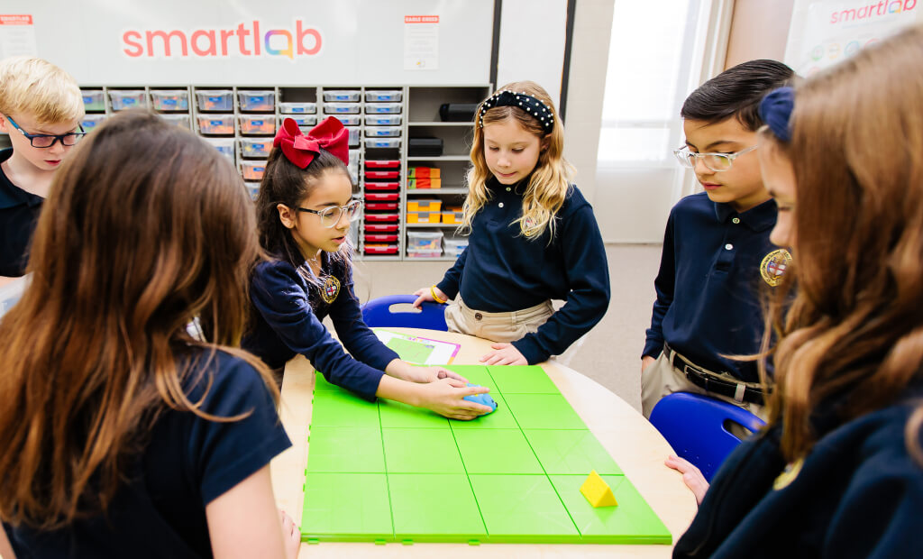 kids in a smart lab classroom play with a STEM related educational toy