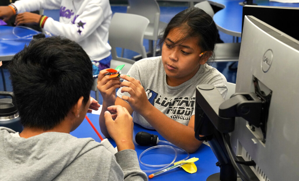 two kids use STEM related educational toys in a smartlab classroom
